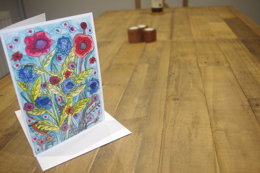 Brighten someone's day with this beautiful card. The self-seeded mix of vibrant red poppies coupled with the calming blues of the wild cornflowers.